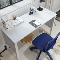 Modern home office desk setup with books, a lamp, and a blue chair near a window.