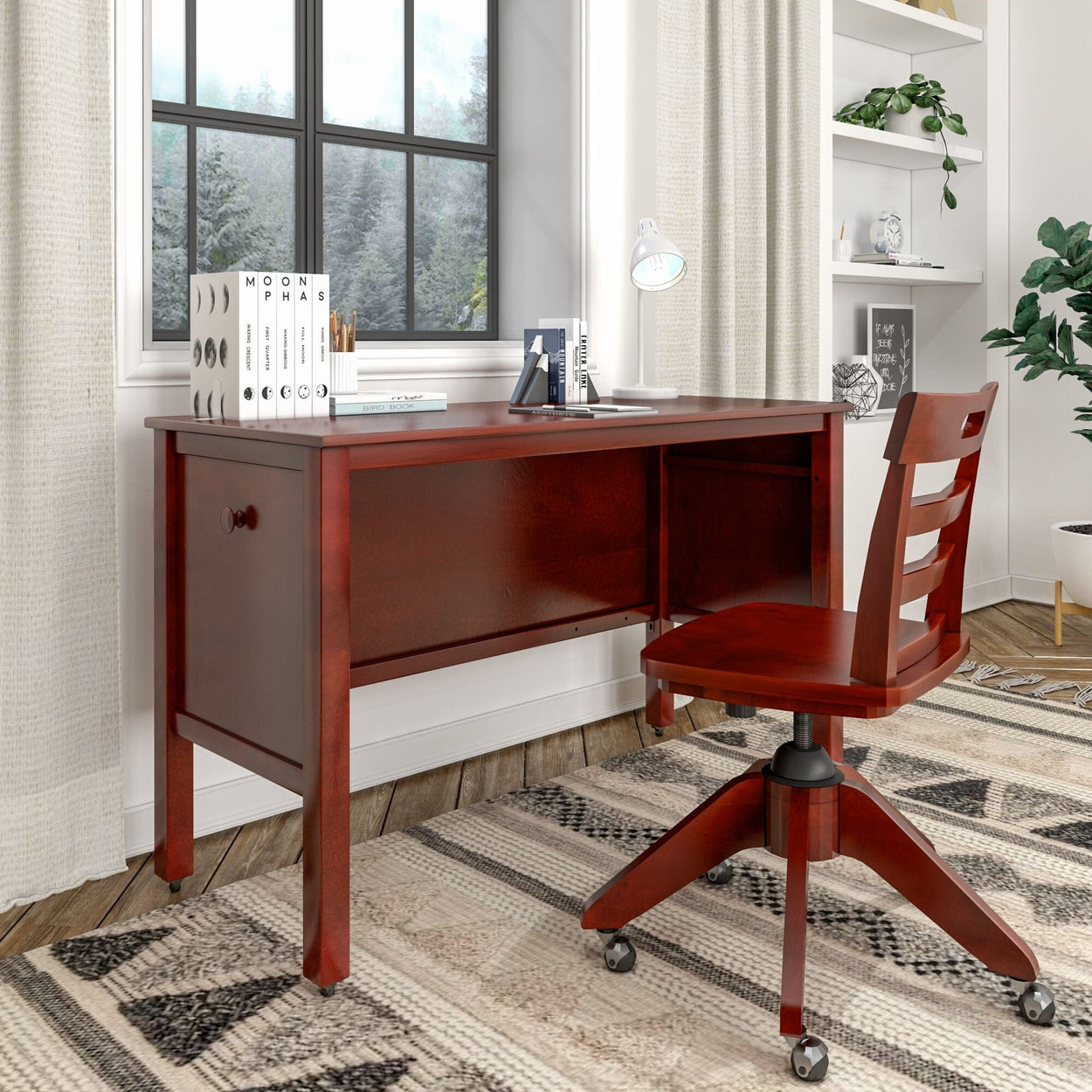 Elegant wooden desk and chair set in a cozy home office with natural light from the window, featuring books and a lamp for a productive workspace.
