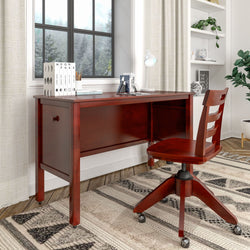 Elegant wooden desk and chair set in a cozy home office with natural light from the window, featuring books and a lamp for a productive workspace.