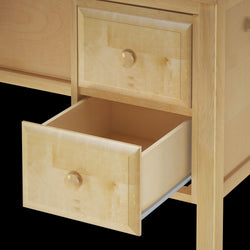 Open wooden drawer of a light-colored dresser, showcasing craftsmanship and storage space.
