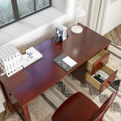 Modern wooden office desk with open drawers, white lamp, and organized stationery near a window.