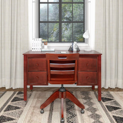 Wooden desk with drawers, chair, and decorative items in a cozy home office setting.