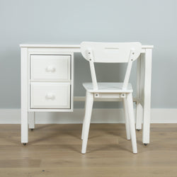 White wooden desk and chair set against blue wall on wooden floor, ideal for home office furniture.