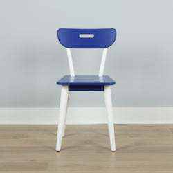 Modern blue and white wooden chair on a light wooden floor against a grey wall, minimalist interior design.