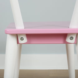 Pink and white children's chair with modern design and sturdy construction.