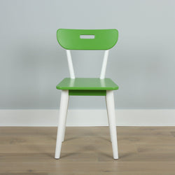 Green and white chair with modern design on a wooden floor against a gray wall.