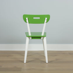 Green wooden chair with white legs on wooden floor, modern minimalist furniture design.