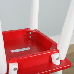 Red and white plastic table close-up showing sturdy leg construction and assembly details.