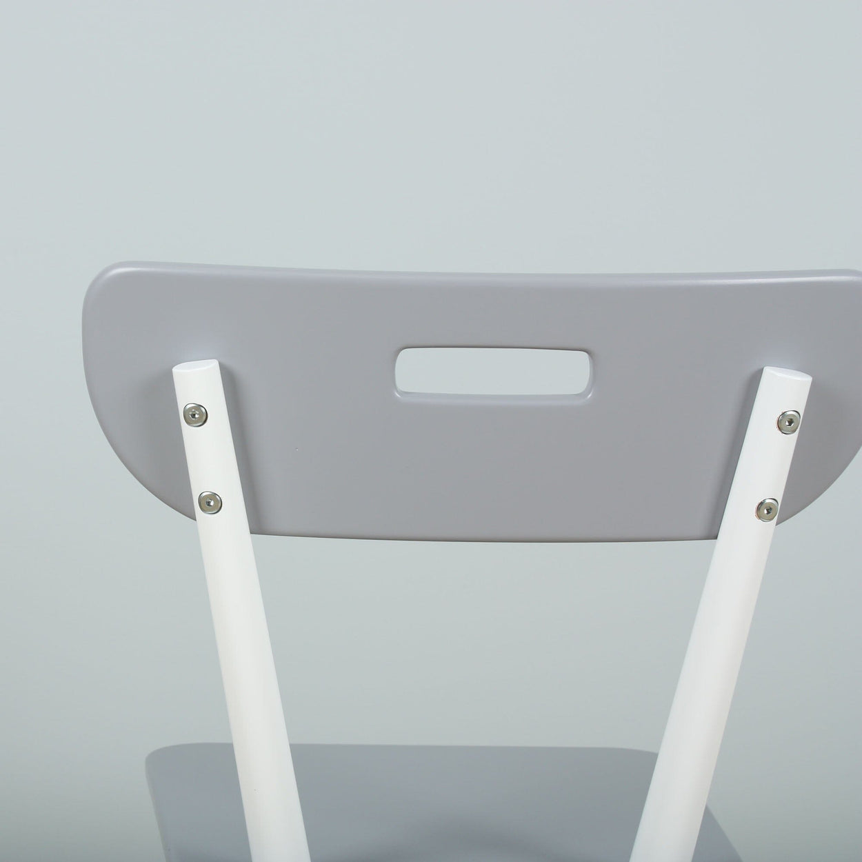Gray and white modern folding chair backrest close-up on light background.