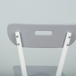 Gray and white modern folding chair backrest close-up on light background.