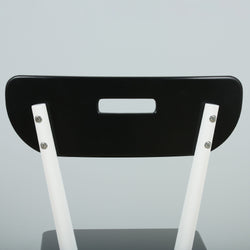 Modern black and white chair with unique backrest design.
