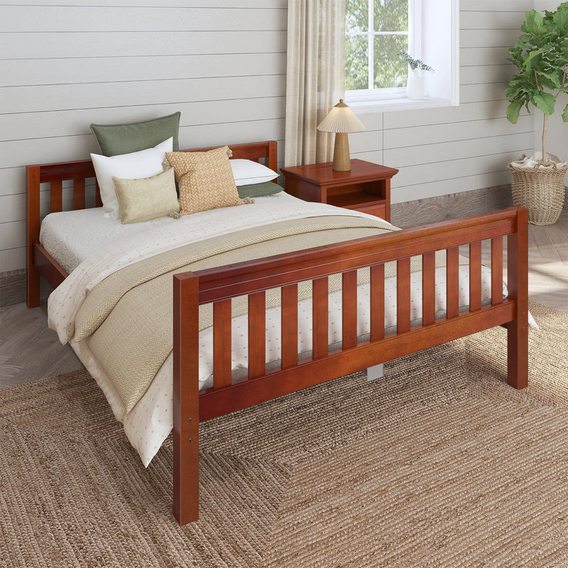 Cozy farmhouse bedroom with wooden slatted bed frame, neutral beige layered bedding and textured throw pillows, wooden nightstand with lamp, linen curtains, shiplap wall, woven jute rug and potted fiddle leaf fig