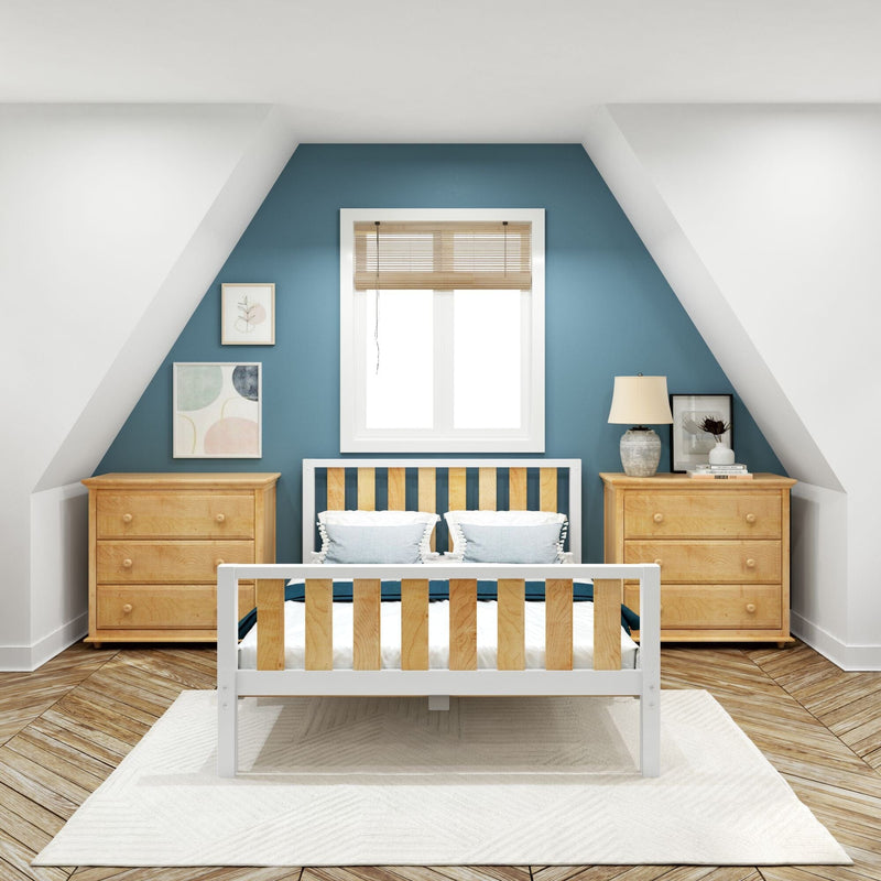 Nursery with teal accent wall and sloped ceiling, white-framed window, wooden crib and matching dressers, bedside lamp and framed art