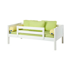 White wooden toddler bed with green and yellow cushions and safety rails.
