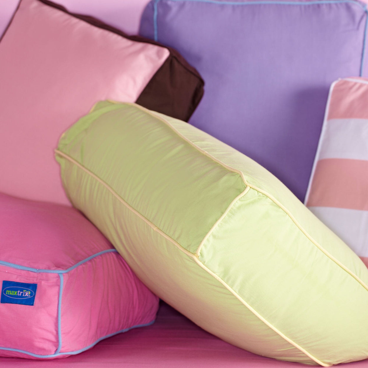 Colorful decorative pillows including pink, green, and purple options for home decor.