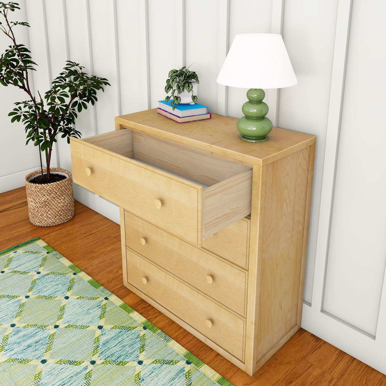 Wooden dresser with open drawer, table lamp, books, and potted plant in stylish bedroom.