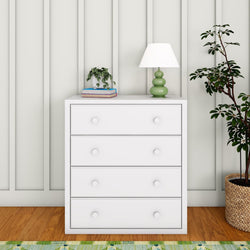 White dresser with green lamp and potted plant, home decor ideas for a modern bedroom setting.
