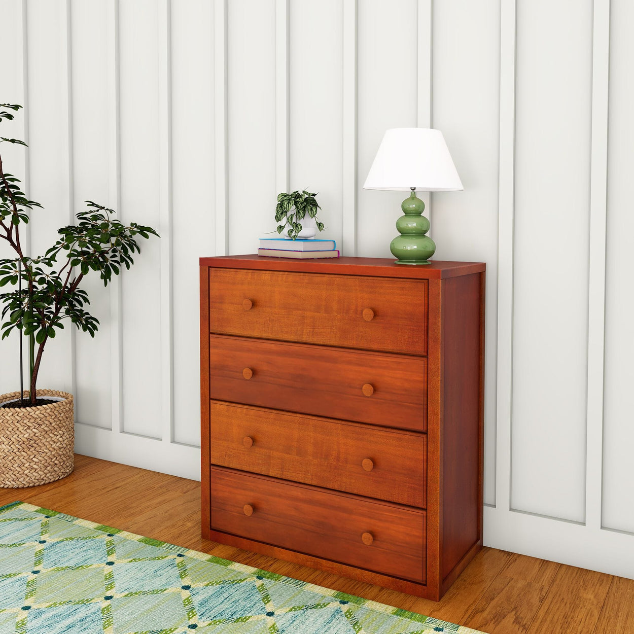 Wooden dresser with four drawers, green lamp, and potted plant in a modern living room setting.