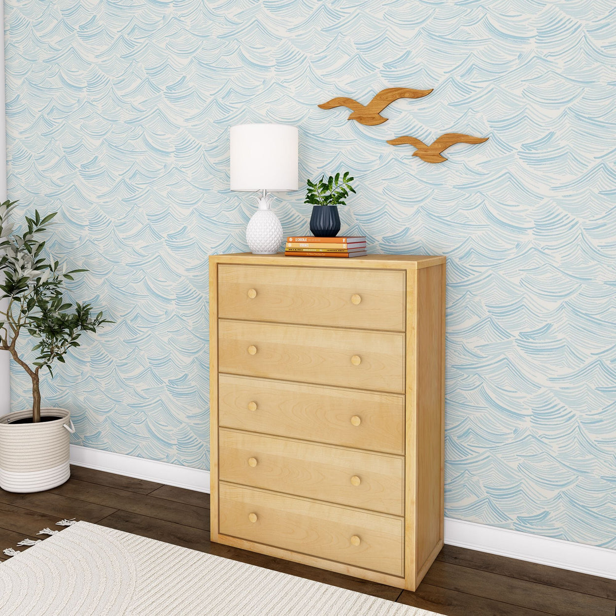 Modern wooden dresser with a lamp and plant beside a blue wave-patterned wall in a stylish room.