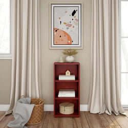 Minimalist living room interior with abstract art, red bookshelf, beige curtains, and decorative items.