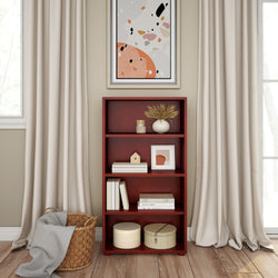 Elegant living room corner with a red wooden bookshelf, abstract wall art, and cozy decor items.