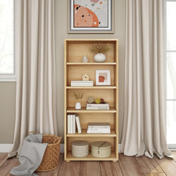 Modern wooden bookshelf with decor items and vases beside large window and curtains.
