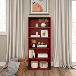 Red wooden bookshelf with decorative items and abstract art in cozy living room.
