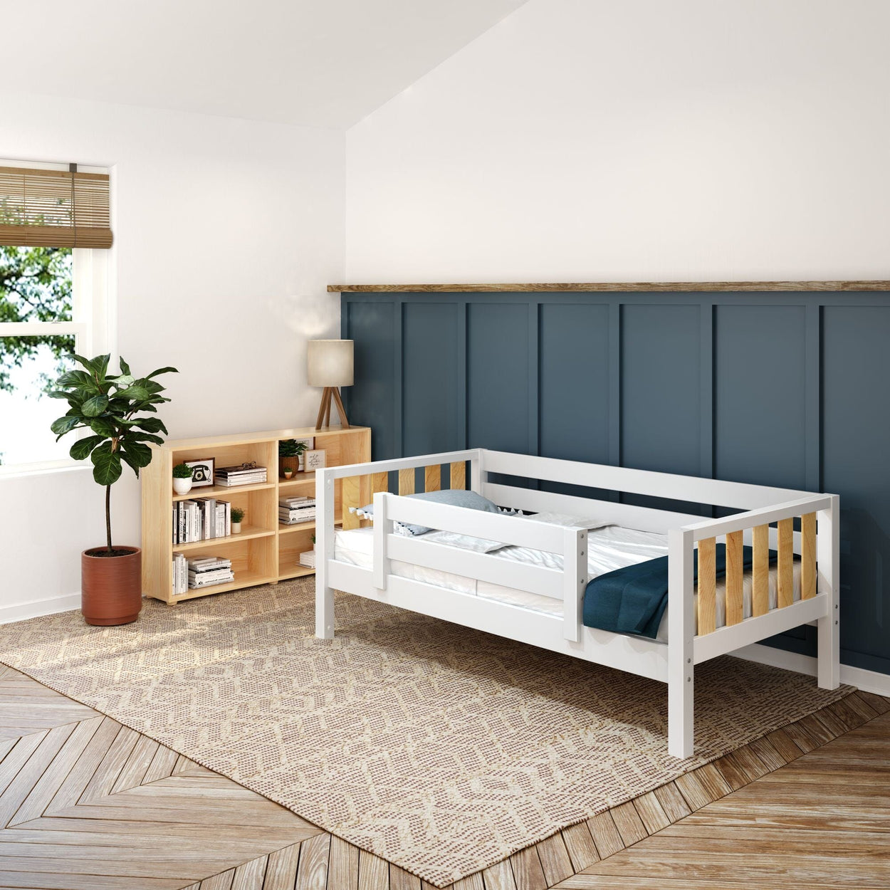 Modern toddler bed in stylish bedroom with bookshelf, plant, and lamp.