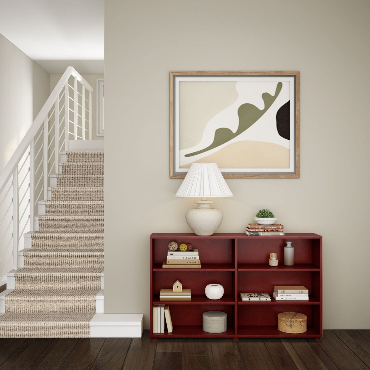 Stylish home interior with modern staircase, abstract wall art, elegant table lamp, and red bookshelf.