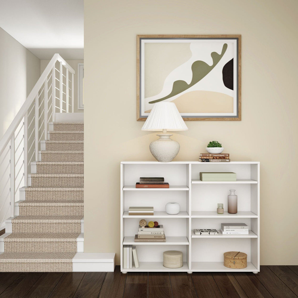 Minimalist living room with modern art, white shelving, and decorative items near a staircase.