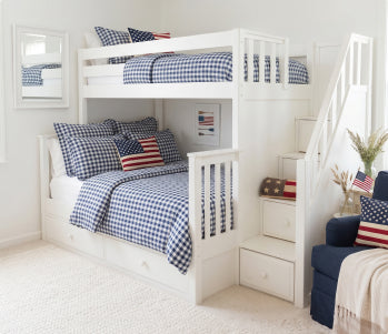 White wooden twin-over-full bunk bed with under-drawer storage, teal and pink bedding and green throw in a modern kids' bedroom.