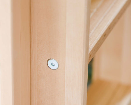 Close up shot of a natural wood finish bunk bed ladder with a hex bolt in the center view.