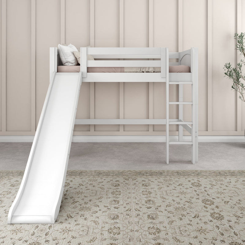 White children's loft bed with slide and ladder in a neutral beige kids' room, pale pink bedding, decorative pillows and patterned rug