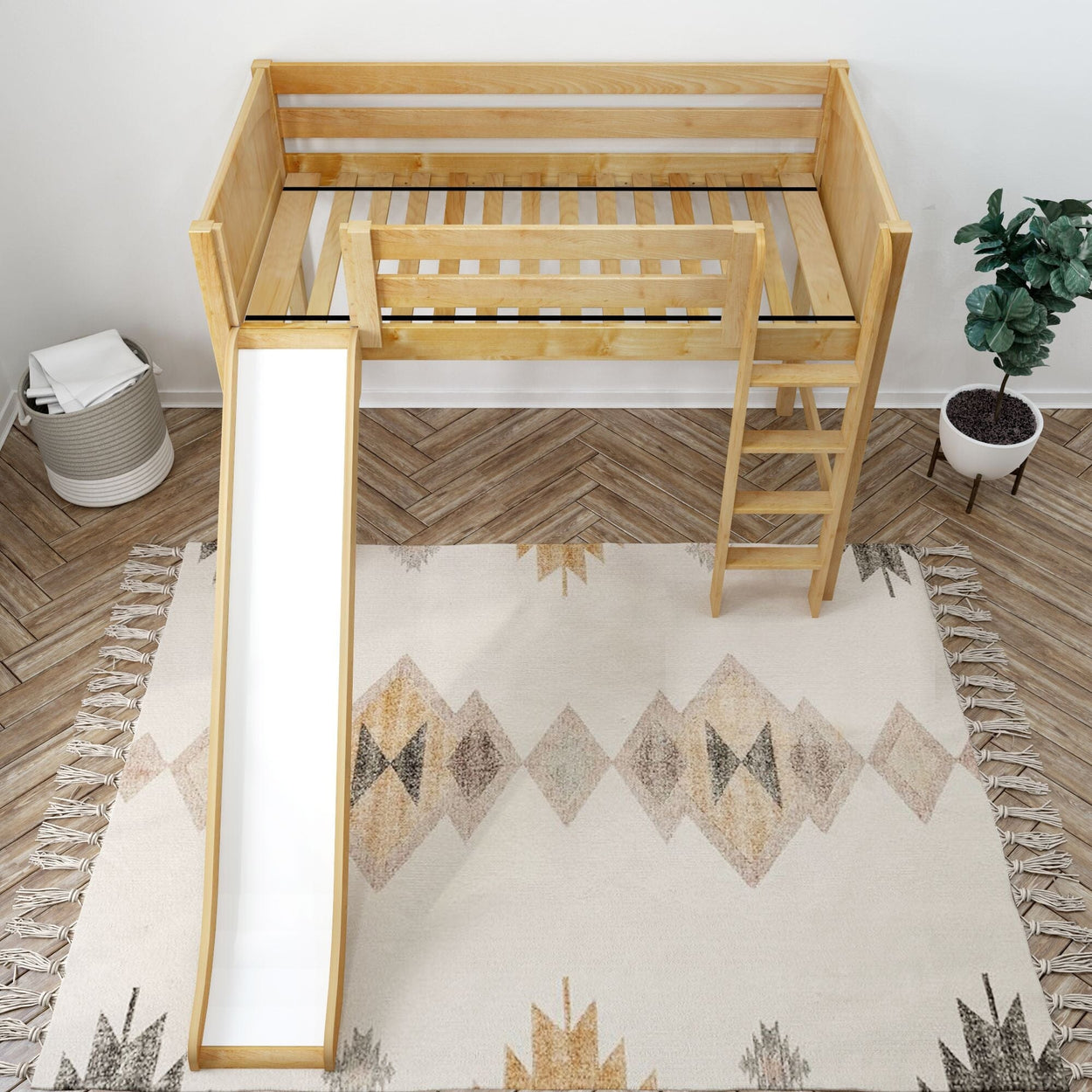 Kids wooden loft bed with slide, ladder, and safety rails in cozy bedroom setting with decorative rug.