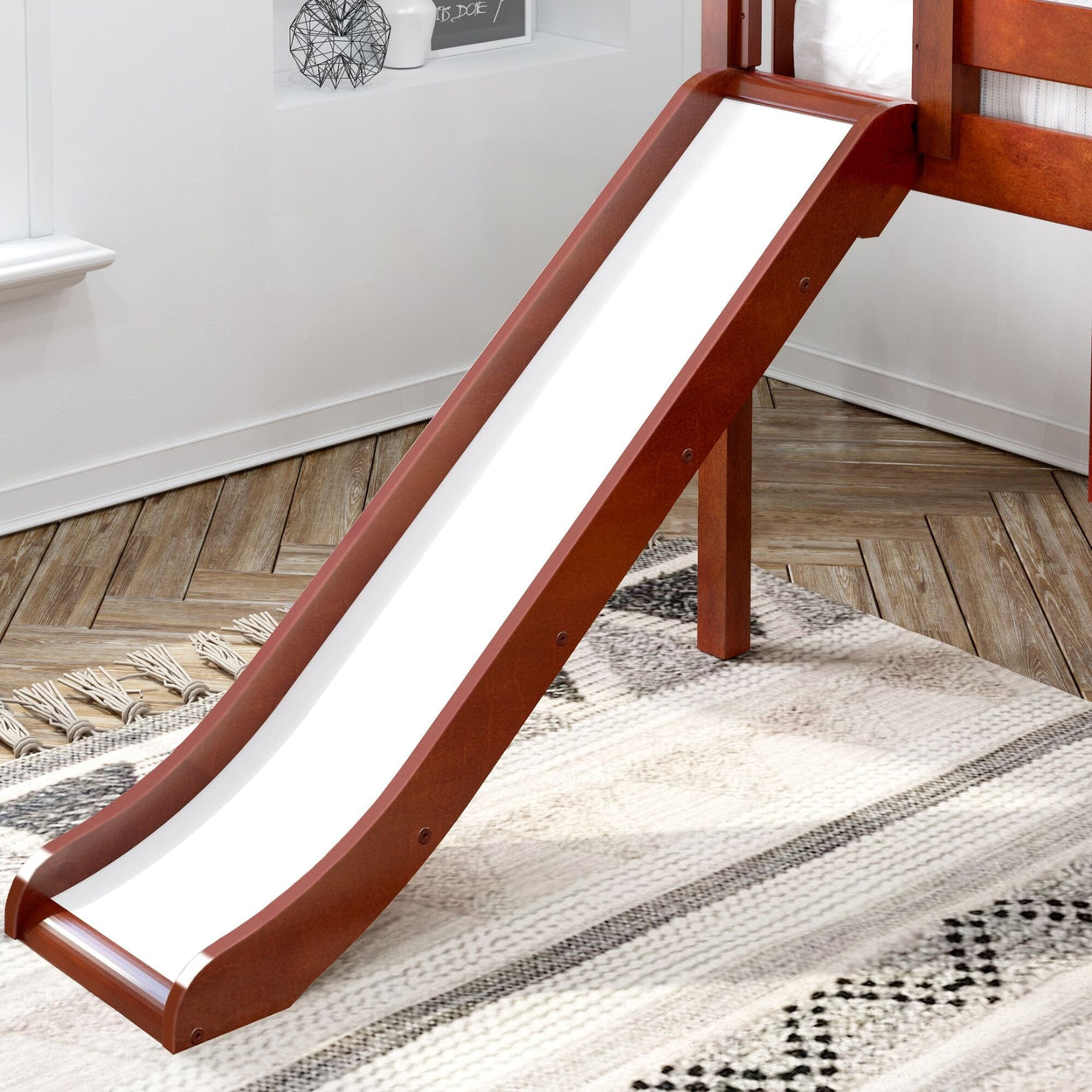 Wooden indoor slide attached to a loft bed on a patterned rug in a child's bedroom.