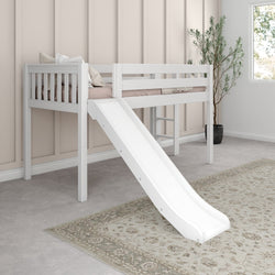 White kids loft bed with slide in a pastel-themed bedroom featuring a cozy rug and decorative pillows.