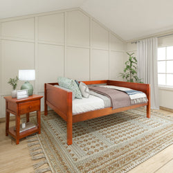 Stylish wooden daybed in a modern bedroom with a cozy textured rug and elegant nightstand.