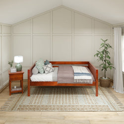 Stylish wooden daybed with cozy cushions and decorative throw in modern bedroom setting.