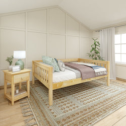 Cozy bedroom with wooden daybed, decorative pillows, side table, and a large window with natural lighting.