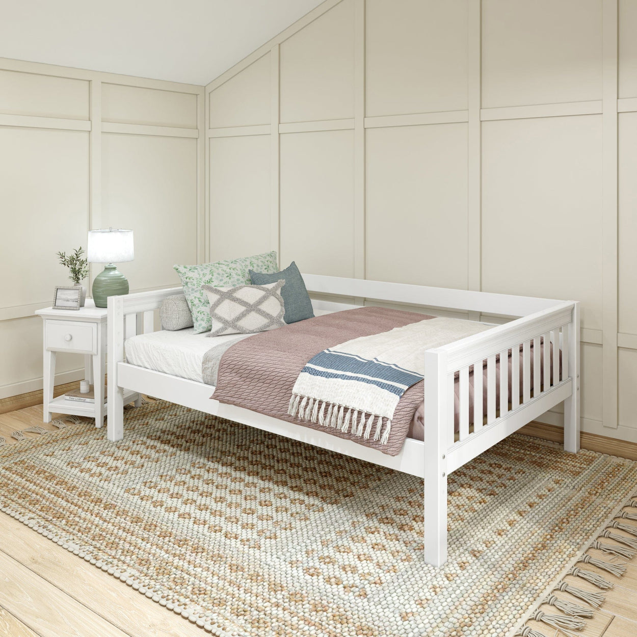 Elegant white daybed in a cozy bedroom setting with decorative pillows and a textured rug.