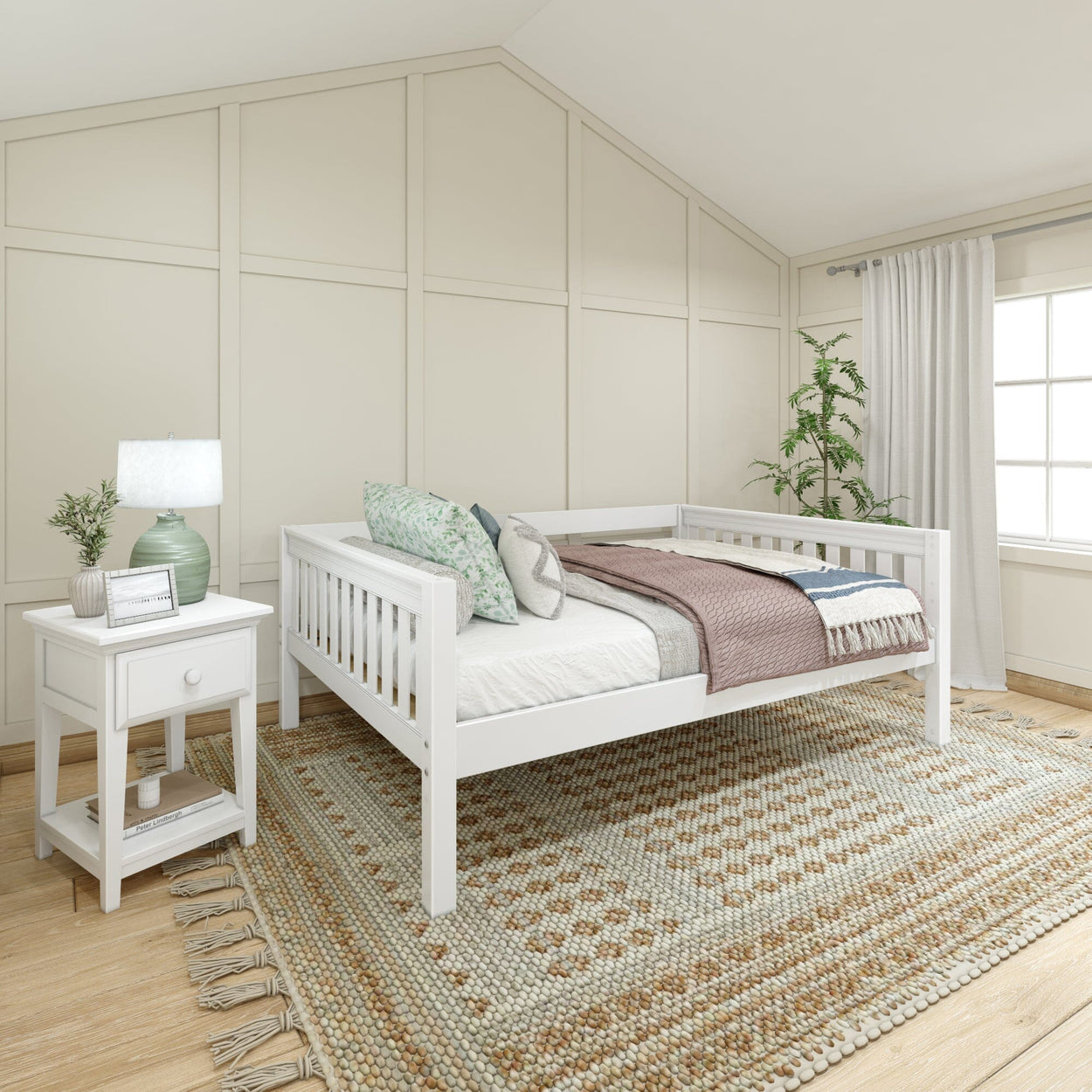 White daybed in modern neutral bedroom with cozy decor and natural lighting.