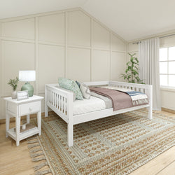 White daybed in modern neutral bedroom with cozy decor and natural lighting.