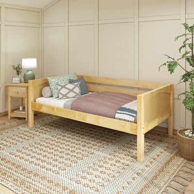 Wooden daybed with cozy pillows and bedside table in a modern bedroom setting.