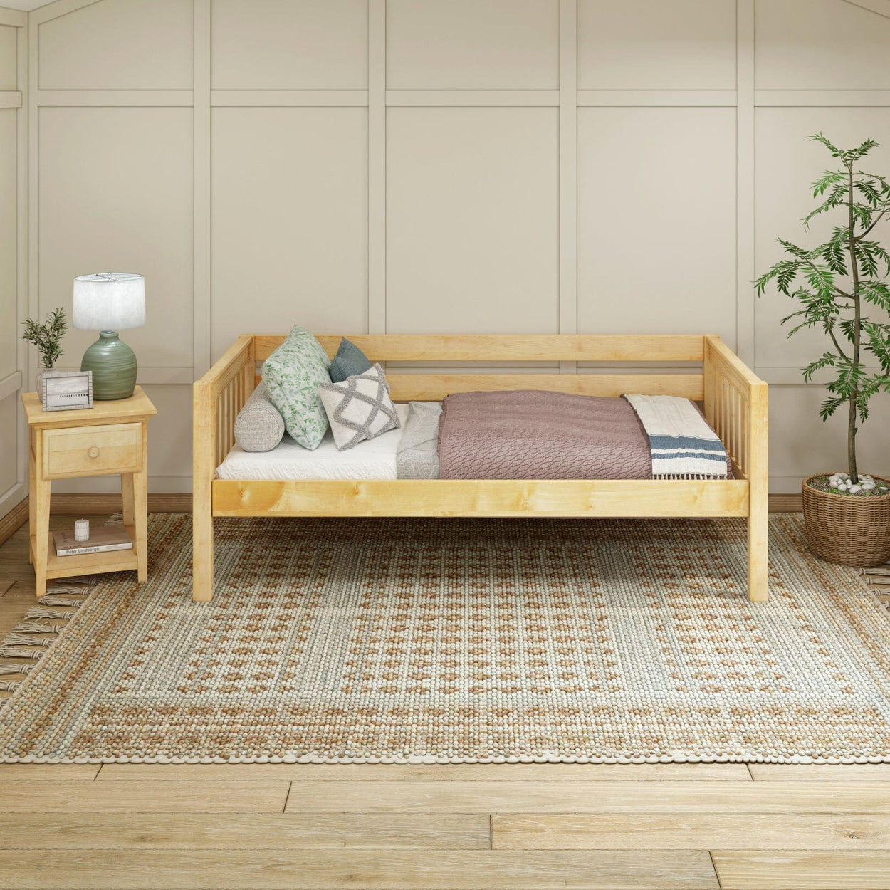 Rustic wooden daybed with pillows and throw blanket, next to a wooden nightstand with a lamp, in a cozy bedroom with a patterned rug and potted plant.