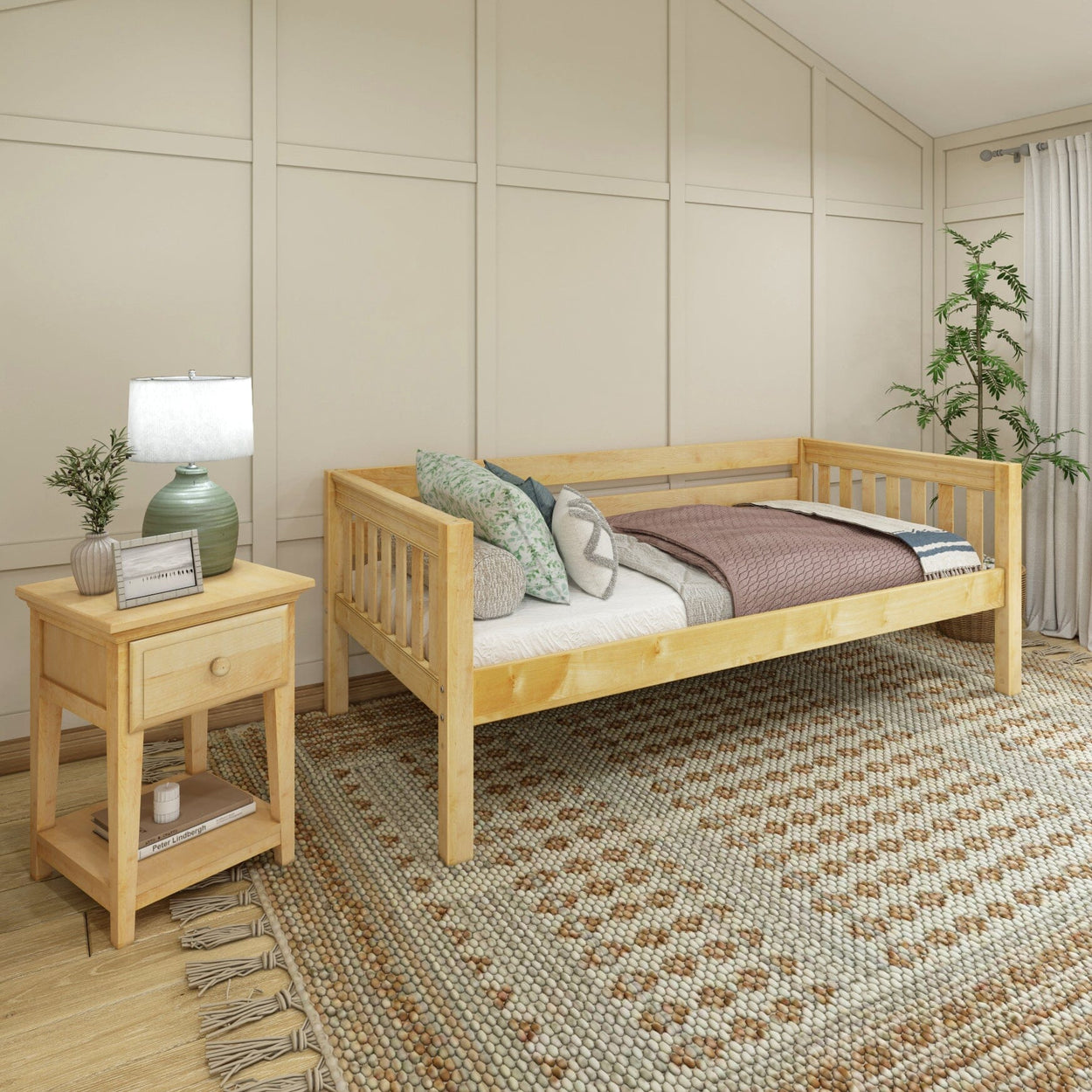 Wooden daybed in a cozy bedroom with decorative pillows, nightstand, and lamp, ideal for relaxing.