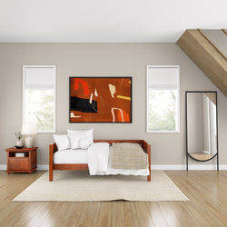 Cozy minimalist bedroom with modern art and wooden furniture.