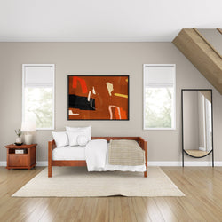 Modern bedroom interior with wooden bed, abstract artwork, large mirror, and natural light.