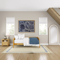 Cozy minimalist bedroom with wooden bed, abstract wall art, and large decorative mirror.