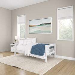Minimalist bedroom with white furniture and blue accents, featuring modern decor and elegant wall art.
