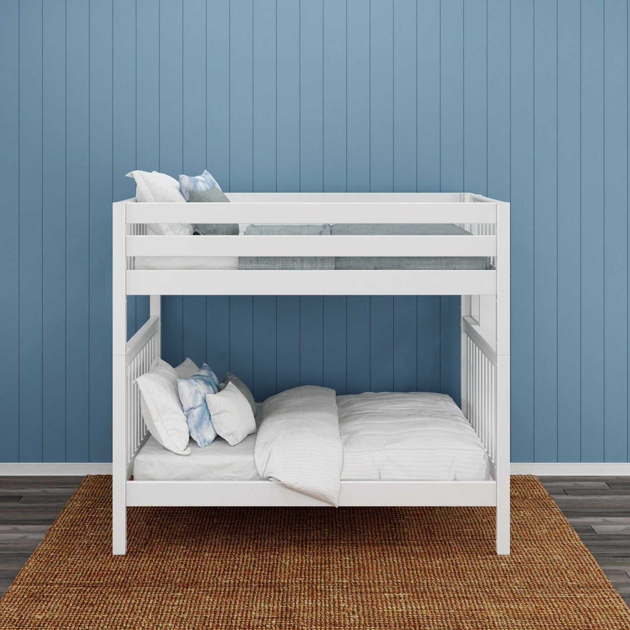 White wooden bunk bed with pillows and blankets against a blue paneled wall in a modern bedroom.